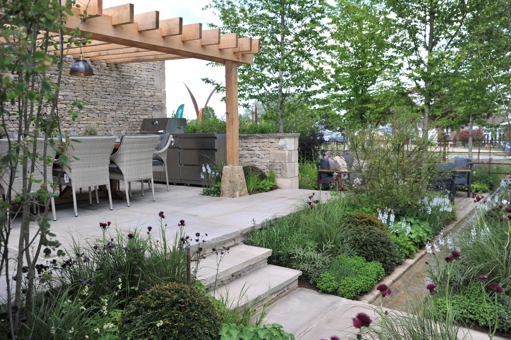 Tranquil garden patio with outdoor dining and lush greenery