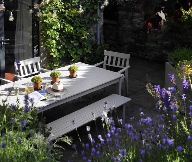 A climbing hydrangea covers the north-facing wall of the paved area immediately outside the kitchen, which provides a cosy spot for entertaining