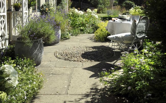 Add interest to paving with a decorative addition, like Marks circle of pebbes